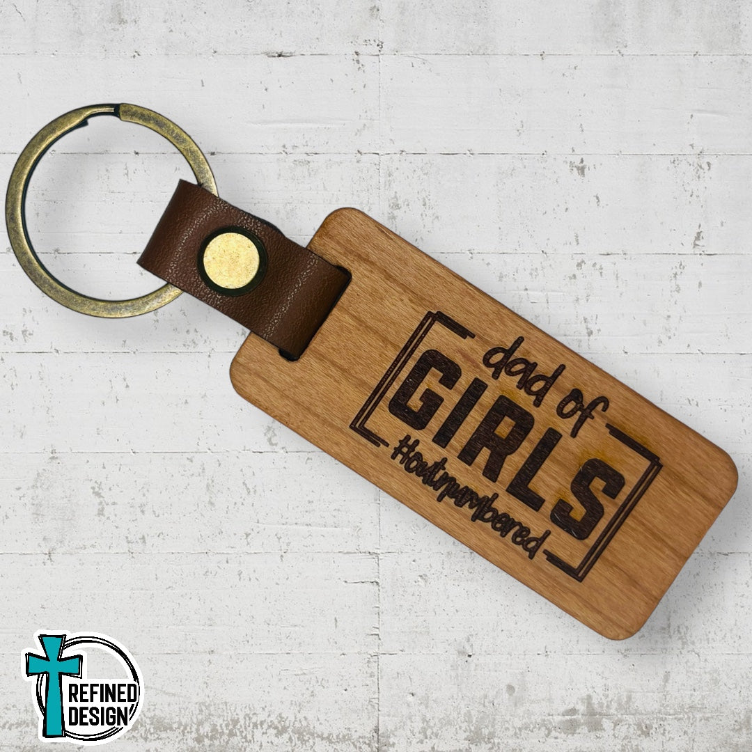 “Dad of Girls #OutNumbered” Wood and Leather Keychain